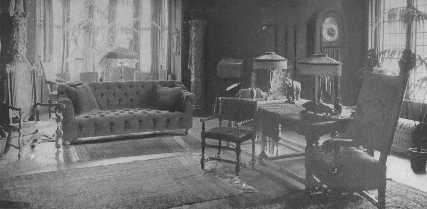 In this living-room, Italian, Jacobean, and modern
 stuffed furniture, give a satisfactory effect because each piece is good
of its kind and is in a certain relationship to each other. The huge
clock with chimes and the animal casts are out of keeping.