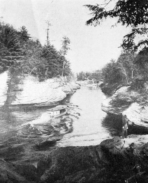 THE NARROWS, DELLS OF THE WISCONSIN

One hundred feet deep. The river seems almost to be running on its edge
hemmed in by ponderous rocks. Courtesy Wisconsin Geological Survey