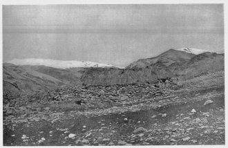 Fig. 24&mdash;This stone hut, grass-thatched, is the highest
permanent habitation in Peru, and is believed to be the highest in the
world. Altitude of 17,100 feet (5,210 m.) determined by instrumental
survey. The general geographic relationships of the region in which the
hut is situated are shown in Fig. 25. For location see the topographic
map, Fig. 204.